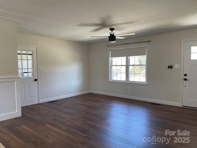 entrance foyer featuring dark wood-type flooring, a ceiling fan, baseboards, and visible vents