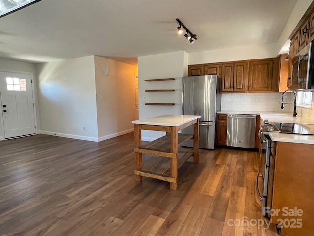 kitchen with tasteful backsplash, light countertops, appliances with stainless steel finishes, dark wood-style floors, and open shelves