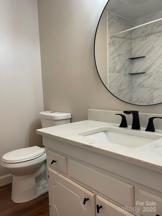 full bathroom featuring vanity, toilet, and wood finished floors