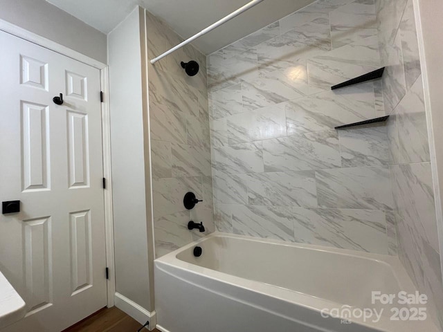 full bath featuring washtub / shower combination and baseboards