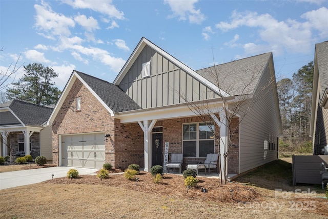 view of front of house with roof with shingles, an attached garage, brick siding, covered porch, and board and batten siding