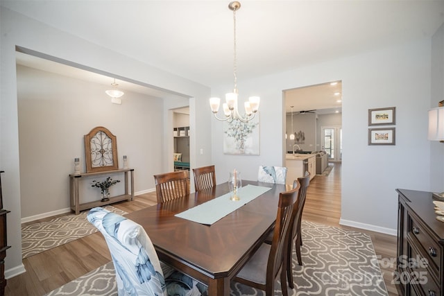 dining area featuring baseboards and light wood finished floors