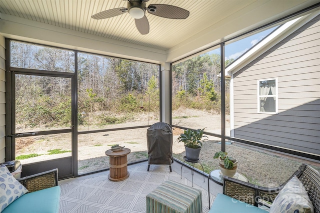 sunroom / solarium featuring a ceiling fan