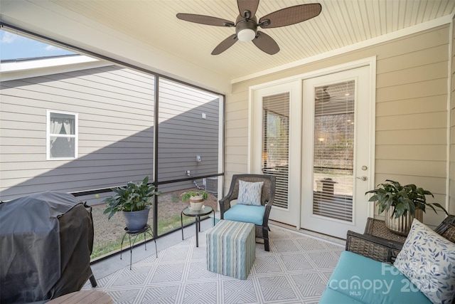 sunroom / solarium featuring wooden ceiling and ceiling fan