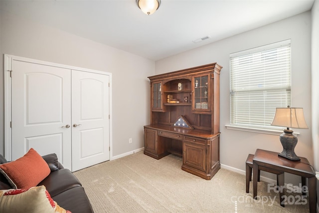 office area with light carpet, visible vents, and baseboards