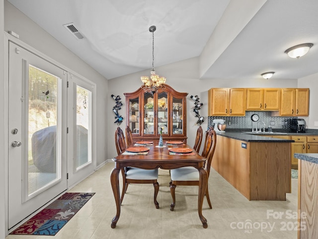 dining area with visible vents and a notable chandelier