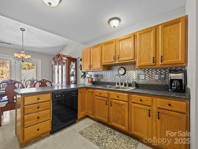 kitchen with dark countertops, a peninsula, black dishwasher, and a sink