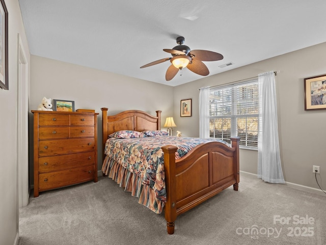 bedroom featuring visible vents, light colored carpet, baseboards, and ceiling fan