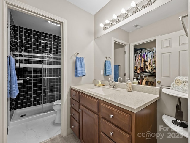 full bath with vanity, visible vents, a stall shower, toilet, and marble finish floor