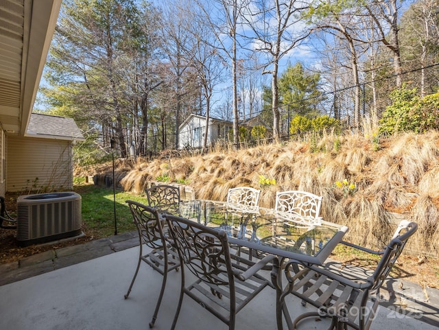 view of patio featuring outdoor dining area and cooling unit