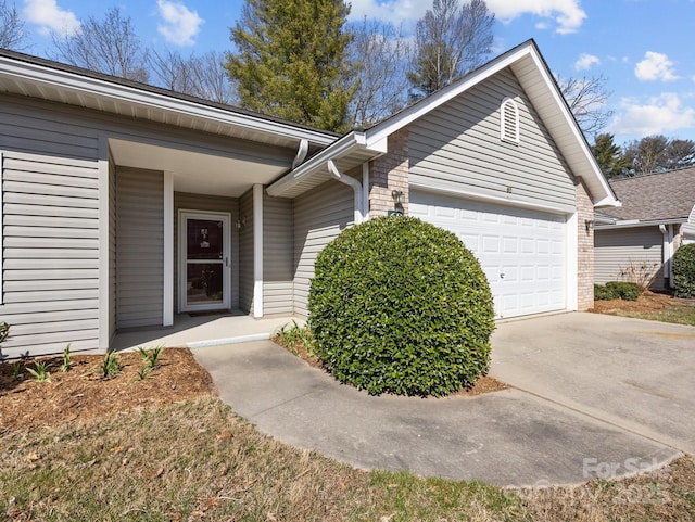 view of front of home featuring concrete driveway and an attached garage