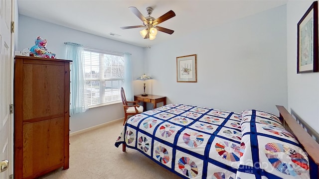 bedroom featuring visible vents, baseboards, light colored carpet, and a ceiling fan