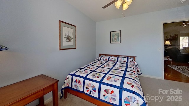 bedroom with carpet flooring, ceiling fan, and vaulted ceiling