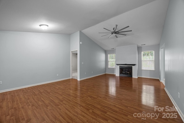 68 Wiltshire Cir, Fletcher, NC 28732 - unfurnished living room with a ceiling fan, vaulted ceiling, wood finished floors, and a fireplace