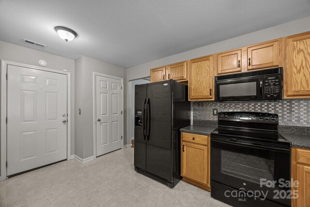 68 Wiltshire Cir, Fletcher, NC 28732 - kitchen with black appliances, dark countertops, tasteful backsplash, and baseboards