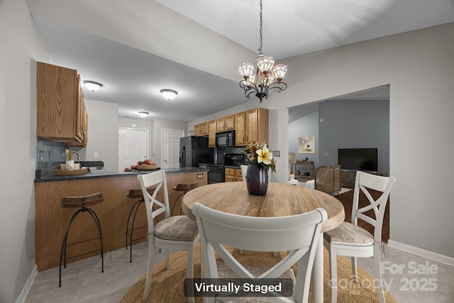 68 Wiltshire Cir, Fletcher, NC 28732 - dining area featuring a chandelier, baseboards, and light tile patterned flooring
