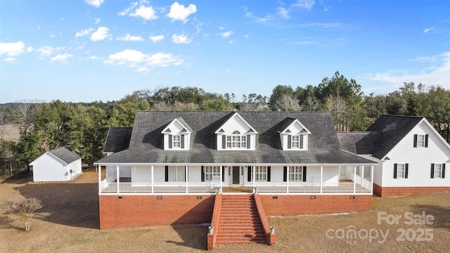 view of front of property featuring an outbuilding and stairway