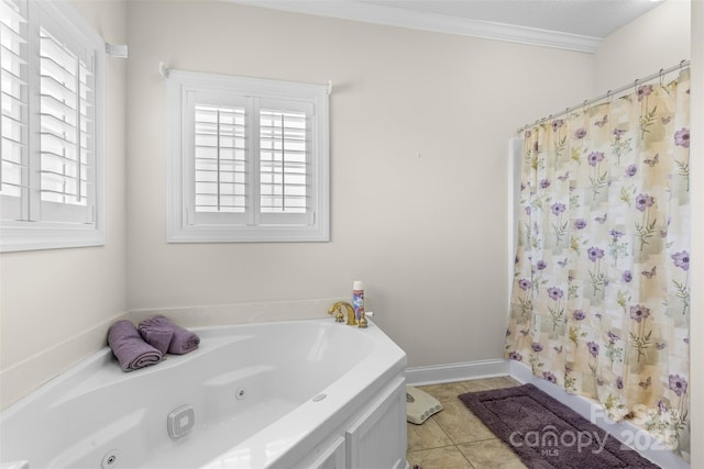 bathroom featuring crown molding, plenty of natural light, a tub with jets, and tile patterned floors