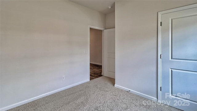 unfurnished bedroom with baseboards and carpet flooring