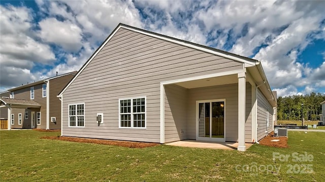 back of house featuring a patio, a yard, and central air condition unit