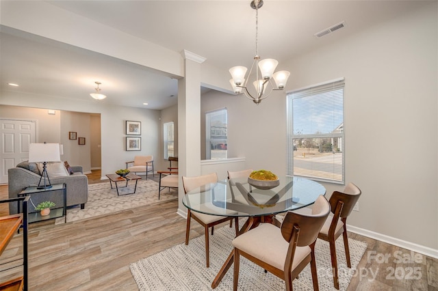 dining room featuring baseboards, visible vents, an inviting chandelier, recessed lighting, and light wood-type flooring