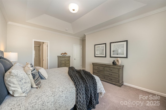 carpeted bedroom featuring baseboards, a raised ceiling, and crown molding