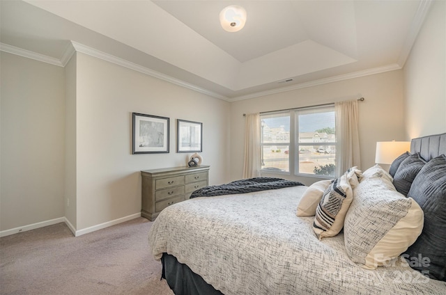 carpeted bedroom with visible vents, a raised ceiling, crown molding, and baseboards