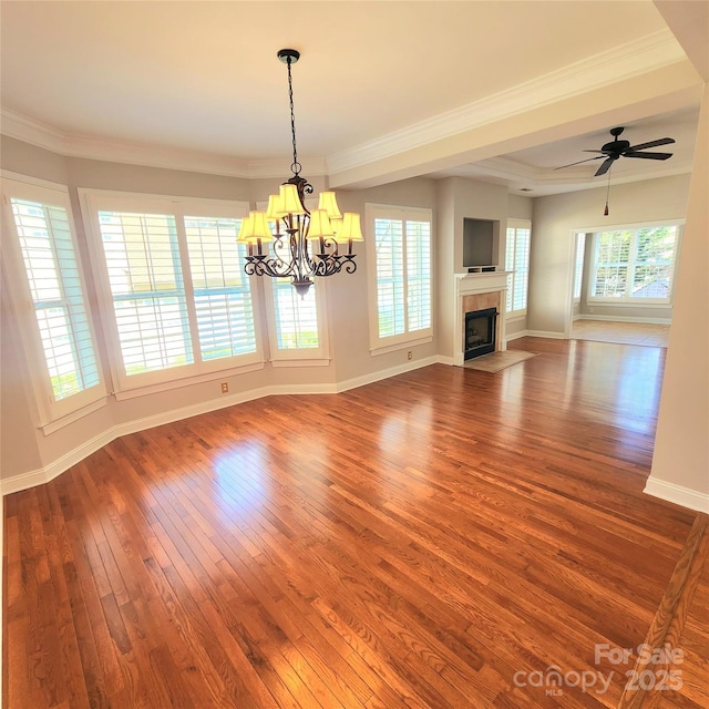 unfurnished living room featuring a fireplace with flush hearth, ornamental molding, baseboards, and wood-type flooring