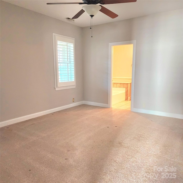 unfurnished room featuring light carpet, ceiling fan, and baseboards