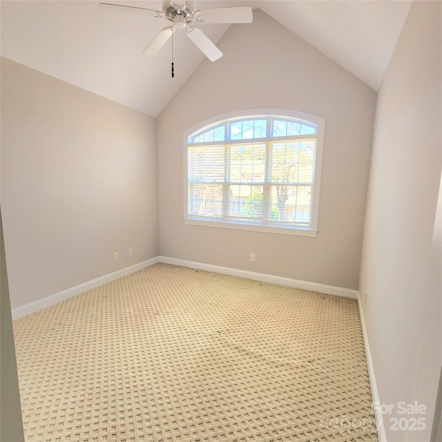 spare room featuring baseboards, light colored carpet, lofted ceiling, and ceiling fan