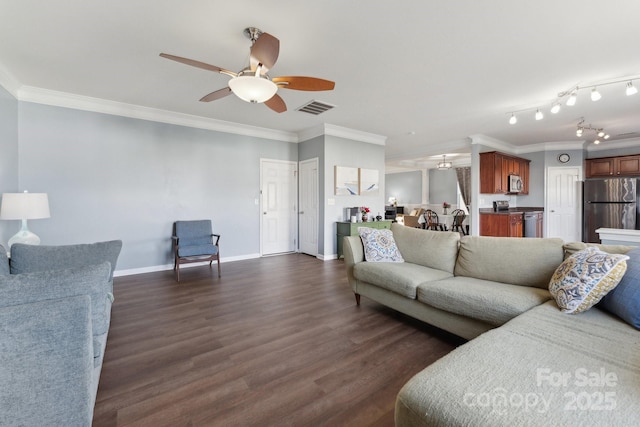 living area featuring dark wood-style floors, visible vents, and crown molding