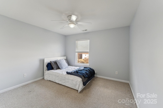 carpeted bedroom with visible vents, ceiling fan, and baseboards