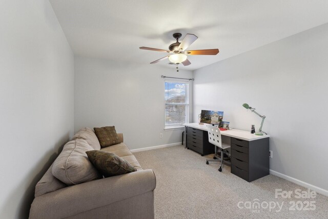 office with baseboards, ceiling fan, and light colored carpet