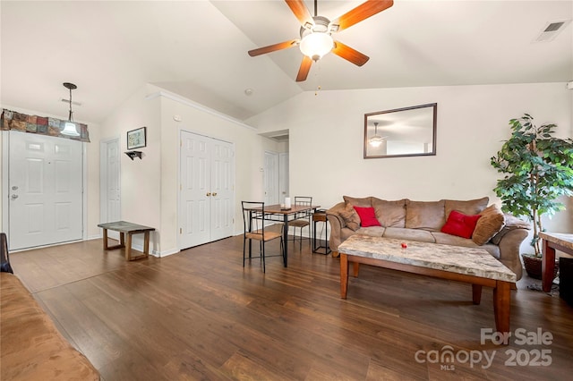 living room featuring visible vents, lofted ceiling, wood finished floors, and a ceiling fan