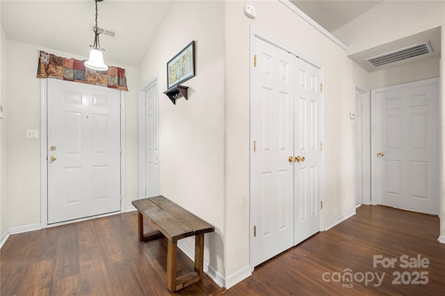 entryway featuring dark wood-type flooring, baseboards, and visible vents