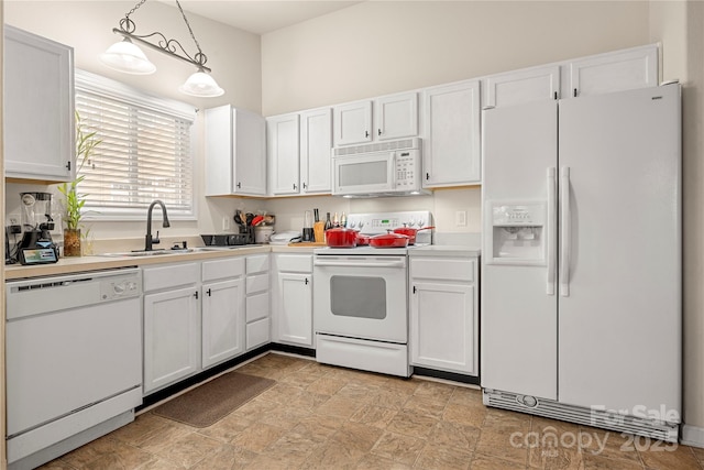 kitchen with white cabinets, white appliances, and a sink