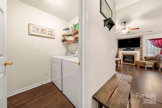 washroom with ceiling fan, laundry area, independent washer and dryer, and dark wood-type flooring