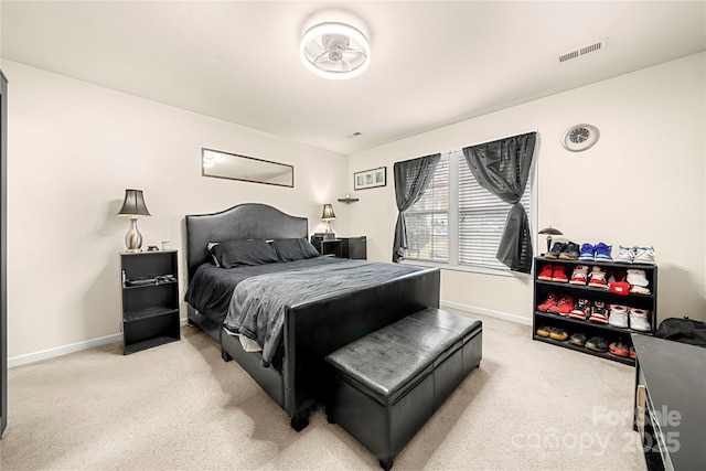 bedroom featuring baseboards, visible vents, and light carpet