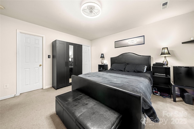bedroom featuring light carpet, visible vents, and baseboards