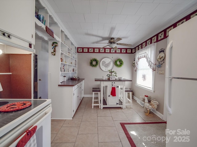 kitchen with light tile patterned flooring, white cabinets, white appliances, a ceiling fan, and open shelves