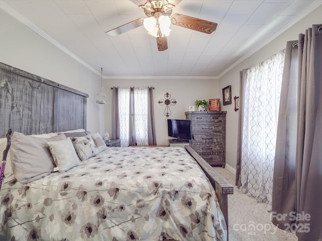 carpeted bedroom with a ceiling fan and ornamental molding