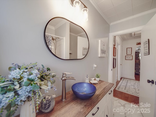 full bathroom featuring vanity and ornamental molding