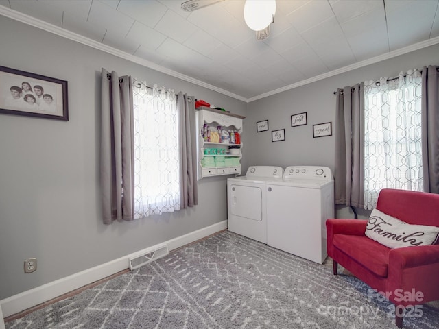 laundry area with visible vents, washing machine and dryer, laundry area, and ornamental molding