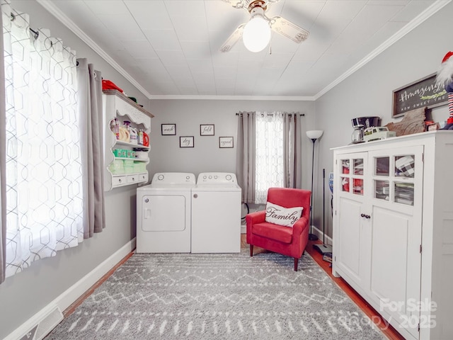 clothes washing area with laundry area, crown molding, separate washer and dryer, and visible vents