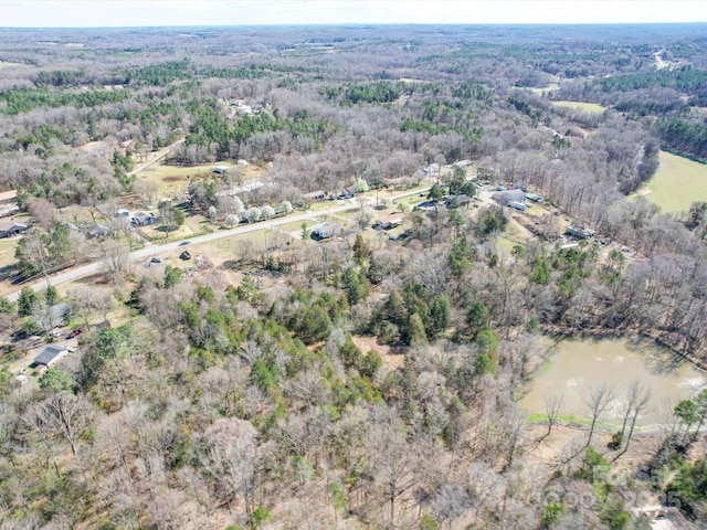 aerial view featuring a view of trees and a water view