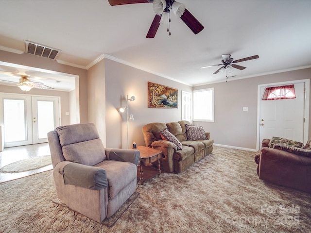 living area featuring visible vents, ornamental molding, french doors, carpet floors, and baseboards