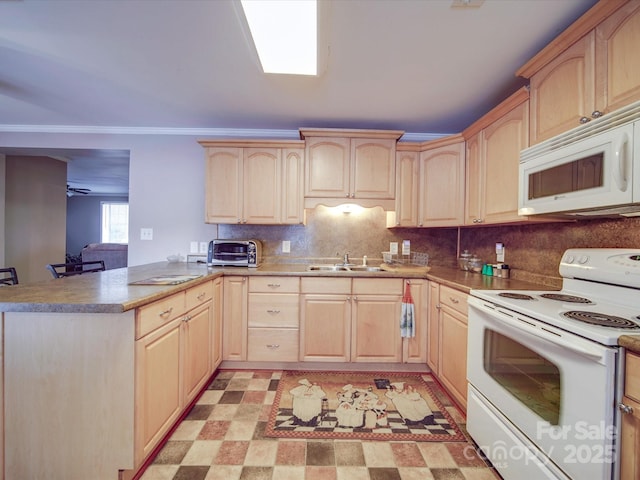 kitchen with white appliances, light floors, a peninsula, a sink, and light brown cabinetry