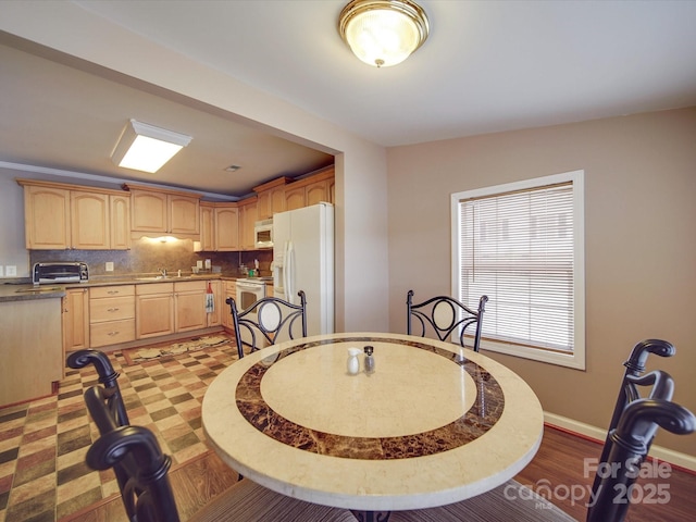 dining area with a toaster and baseboards