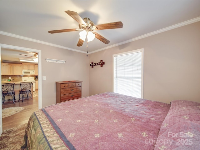 bedroom with ceiling fan, light wood-style flooring, and ornamental molding