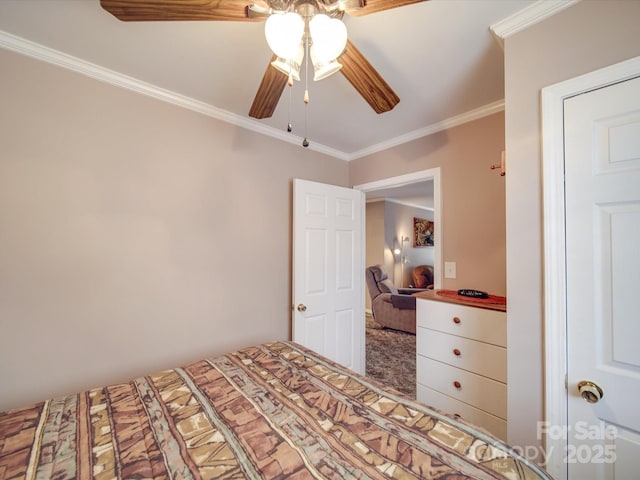 bedroom featuring carpet floors, ceiling fan, and crown molding